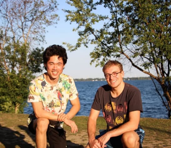 FreshFind's two co-founders outdoors by the water on the day they signed their first client in 2020
